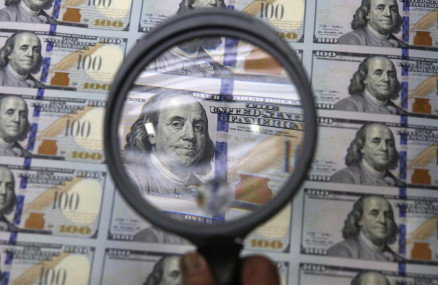 A sheet of uncut $100 bills is inspected during the printing process at the Bureau of Engraving and Printing Western Currency Facility in Fort Worth, Texas, on Sept. 24, 2013. AP/RSS Photo